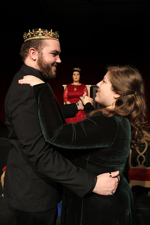 Henry and Anne dance with Katharine in the background